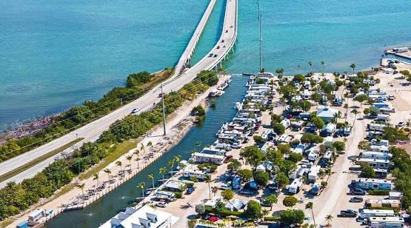 Aerial view of Sunshine Key RV Resort and Marina in the Florida Keys with Overseas Highway and Seven Mile Bridge in the background.Rv park in florida