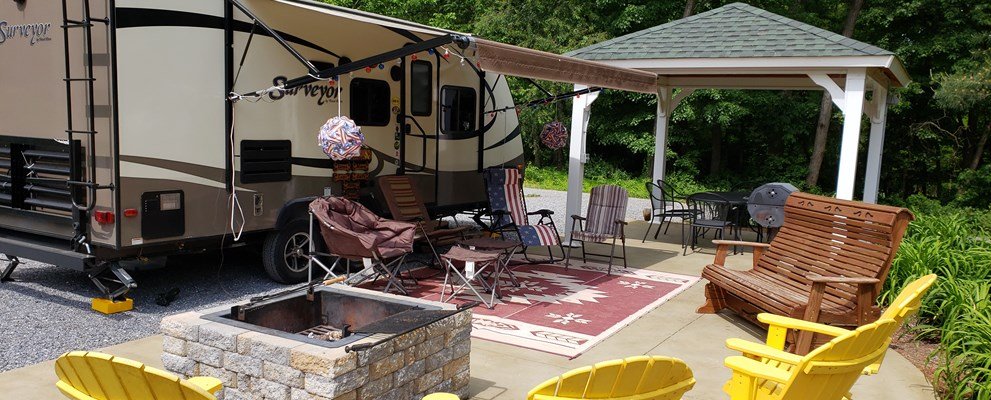 Deluxe patio RV site with outdoor seating at Elizabethtown Hershey KOA Holiday near Hershey, PA