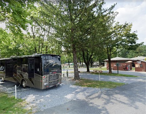 Class A motorhome parked under mature shade trees at Harrisburg East Campground near Hershey, PA