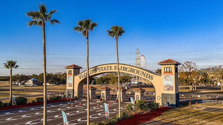 Rows of motorhomes and RVs parked under palm trees at Florida State Fairgrounds in Tampa, Florida