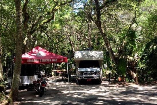 Travel trailer set up at a wooded campsite in Anastasia State Park in St. Augustine, Florida
