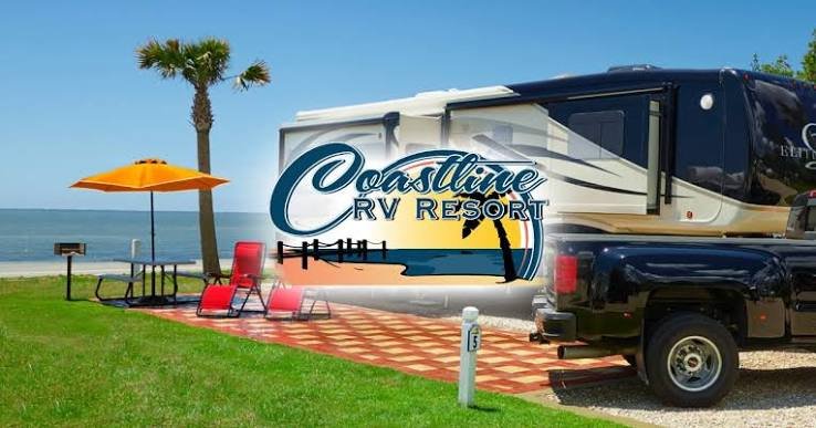 Coastline RV Resort entrance sign with a travel trailer parked in front on a sunny day in Eastpoint, Florida